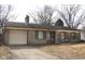 Charming single-story home with stone exterior, attached garage and driveway at 7625 E 35Th St, Indianapolis, IN 46226