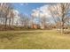 Expansive backyard with a well-maintained lawn and mature trees, offering a serene and private outdoor space at 7806 Ashtree Dr, Indianapolis, IN 46259