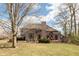 Spacious backyard showcasing a well-maintained lawn, mature trees, and a comfortable outdoor seating area at 7806 Ashtree Dr, Indianapolis, IN 46259