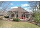 Brick patio with outdoor seating, grill, and manicured landscaping, ideal for outdoor gatherings and relaxation at 7806 Ashtree Dr, Indianapolis, IN 46259