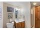 Well-lit bathroom featuring a vanity with a sink, a framed mirror, and a shower with a glass door at 7806 Ashtree Dr, Indianapolis, IN 46259