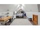 Cozy attic bedroom with a desk area and a sloped ceiling, perfect for relaxation and productivity at 7806 Ashtree Dr, Indianapolis, IN 46259