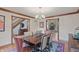 Elegant dining room with hardwood floors, a stylish chandelier, a large dining table, and easy access to other rooms at 7806 Ashtree Dr, Indianapolis, IN 46259