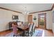 Formal dining room with hardwood floors, a chandelier, an elegant dining table, and views to the backyard at 7806 Ashtree Dr, Indianapolis, IN 46259