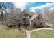 Beautiful two-story brick home with well-manicured landscaping and a charming walkway leading to the entrance at 7806 Ashtree Dr, Indianapolis, IN 46259