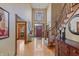 Elegant foyer featuring a grand staircase, chandelier, hardwood floors, and a stylish entryway at 7806 Ashtree Dr, Indianapolis, IN 46259
