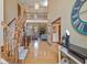 Inviting foyer featuring hardwood floors, staircase, and views into the living spaces at 7806 Ashtree Dr, Indianapolis, IN 46259