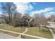 Charming single-Gathering home with a lush green lawn, mature trees, and a welcoming brick walkway at 7806 Ashtree Dr, Indianapolis, IN 46259