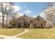 Charming brick home featuring a manicured lawn and winding brick walkway leading to the front entrance at 7806 Ashtree Dr, Indianapolis, IN 46259