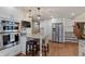 Bright kitchen with granite island and stainless steel appliances and eat-in dining. Stairs and fridge in the background at 7806 Ashtree Dr, Indianapolis, IN 46259