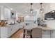 Bright kitchen with white cabinets, granite countertops, stainless steel appliances, and hardwood flooring at 7806 Ashtree Dr, Indianapolis, IN 46259