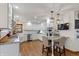 Bright kitchen featuring white cabinets, granite countertops, stainless steel appliances, hardwood flooring, and eat-in bar at 7806 Ashtree Dr, Indianapolis, IN 46259