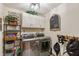 Efficient laundry room with stainless steel washer, dryer and storage, plus unique decor at 7806 Ashtree Dr, Indianapolis, IN 46259