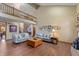 Bright, two-story living room with hardwood floors and a cozy seating area at 7806 Ashtree Dr, Indianapolis, IN 46259