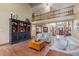 Bright, two-story living room showcasing hardwood floors, a decorative cabinet, and comfortable seating at 7806 Ashtree Dr, Indianapolis, IN 46259