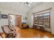 Bright home office with hardwood floors, a desk, a chair, and a large window providing ample natural light at 7806 Ashtree Dr, Indianapolis, IN 46259