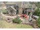 Brick patio area with outdoor furniture, including red Adirondack chairs, perfect for relaxation and entertaining at 7806 Ashtree Dr, Indianapolis, IN 46259