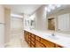 Bathroom with double sinks, vanity, and tiled floor, and a large walk-in closet at 7914 King Post Dr, Indianapolis, IN 46237