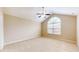 Large bedroom featuring neutral carpet, a ceiling fan, and a large window for natural light at 7914 King Post Dr, Indianapolis, IN 46237
