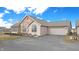 A lovely home exterior featuring a stone accent, attached garage, and well-kept landscaping at 7914 King Post Dr, Indianapolis, IN 46237