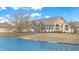 Charming exterior view of a stone and siding home with a beautiful pond in the front yard at 7914 King Post Dr, Indianapolis, IN 46237