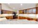 Spacious kitchen featuring granite countertops, wood cabinets, and stainless steel appliances at 7914 King Post Dr, Indianapolis, IN 46237