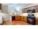 Well-equipped kitchen with wood cabinets, granite countertops, and modern stainless steel appliances at 7914 King Post Dr, Indianapolis, IN 46237