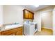 Functional laundry room with washer, dryer, utility sink, and cabinets providing convenience for laundry chores at 7914 King Post Dr, Indianapolis, IN 46237