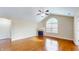 Inviting living room showcasing hardwood floors, a fireplace, and large windows for ample natural light at 7914 King Post Dr, Indianapolis, IN 46237