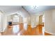Spacious living room with hardwood floors, a fireplace, and multiple doorways for easy flow throughout the house at 7914 King Post Dr, Indianapolis, IN 46237