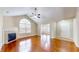 Spacious living room featuring gleaming hardwood floors, a cozy fireplace, and lots of natural light at 7914 King Post Dr, Indianapolis, IN 46237