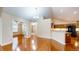 Open-concept living room with hardwood floors and view of the kitchen and a bright sunroom at 7914 King Post Dr, Indianapolis, IN 46237