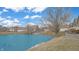 Scenic pond view with mature tree and well-maintained landscaping surrounding the property at 7914 King Post Dr, Indianapolis, IN 46237