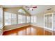 Sun-drenched sunroom with hardwood floors, large windows, and vaulted ceilings offering tranquil views at 7914 King Post Dr, Indianapolis, IN 46237
