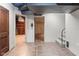 Entry to finished basement with tile flooring, offering a versatile area for additional living space and storage at 906 Franklin St, Columbus, IN 47201