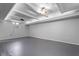 Open basement space with coffered ceilings and recessed lighting, offering a versatile area for recreation and storage at 906 Franklin St, Columbus, IN 47201