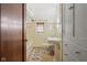 Well-lit bathroom with beige tile, classic fixtures, tub, and linen cabinet at 906 Franklin St, Columbus, IN 47201