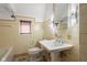 Traditional bathroom featuring beige tiling, pedestal sink, and classic finishes at 906 Franklin St, Columbus, IN 47201