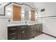 Bathroom with black and white tiling, dual sinks, and ample counter and cabinet space at 906 Franklin St, Columbus, IN 47201