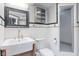 Bathroom showcases classic black and white tile, a framed mirror, and a glass enclosed shower at 906 Franklin St, Columbus, IN 47201