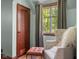 Cozy bedroom featuring a window nook, a comfortable armchair, and a storage closet at 906 Franklin St, Columbus, IN 47201