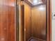 Interior of private residential elevator with wood paneled walls and doors at 906 Franklin St, Columbus, IN 47201