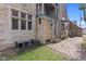 Exterior of a stone house with a charming balcony, multi-pane windows, and a brick paved walkway at 906 Franklin St, Columbus, IN 47201