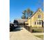 Beautiful stone home featuring manicured landscaping, a spacious driveway, and a black metal fence at 906 Franklin St, Columbus, IN 47201