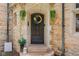 Charming front entrance featuring a decorative wreath, potted plants, and welcoming decor at 906 Franklin St, Columbus, IN 47201