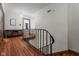 Bright hallway with hardwood floors and classic architectural details, cabinet, and doors at 906 Franklin St, Columbus, IN 47201