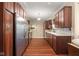 Kitchen with stainless appliances, wood cabinets and trim, and hardwood floors at 906 Franklin St, Columbus, IN 47201