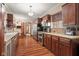 Spacious kitchen with stainless appliances, wood cabinets, and an adjacent breakfast nook at 906 Franklin St, Columbus, IN 47201