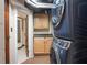 Modern laundry area with front-loading washer and dryer and convenient cabinets at 906 Franklin St, Columbus, IN 47201