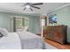 Main bedroom with ceiling fan, dresser and TV, with decorative nook and view to hallway at 906 Franklin St, Columbus, IN 47201